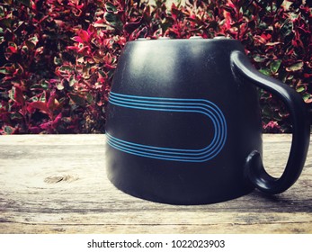 Coffee mug, red tree background, beautiful natural light wood floor.