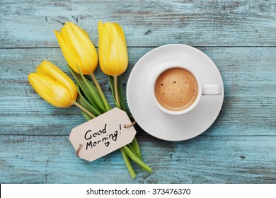 Coffee Mug With Yellow Tulip Flowers And Notes Good Morning On Blue Rustic Table From Above, Breakfast On Mothers Day Or Womens Day