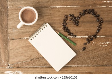 Coffee and note with pencil on the texture old wood.