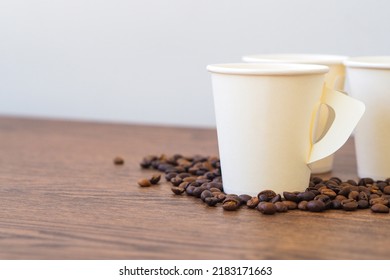 Coffee Paper Cup On Wooden Table. Mockup For You Designs.