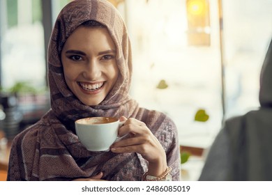 Coffee, portrait and muslim woman in cafe with hijab for relax, happiness or peaceful lunch break. Smile, cup and islamic person in restaurant with cappuccino, warm beverage or latte on weekend - Powered by Shutterstock