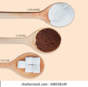 Coffee Powder And Creamer With Sugar Cubes On Wooden Spoon