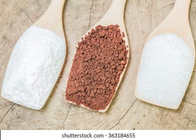 Coffee Powder And Creamer With Sugar Cubes On Wooden Spoon