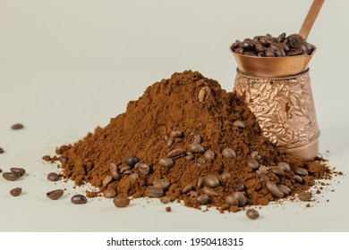 Coffee powder and roasted coffee beans on white background. Turk with coffee.