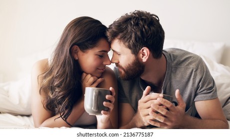 Coffee And Quality Time, Perfection. Shot Of A Happy Young Couple Having Coffee Together In Bed At Home.