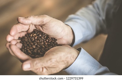 Coffee is a remedy for relaxation. Senior man holding powder coffee in hands. Close up. - Shutterstock ID 1229731399