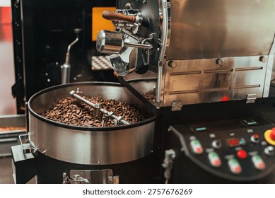 Coffee roasting machine processing beans inside metal drum, rotating and heating coffee beans, production process, industrial food.