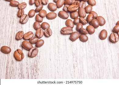 Coffee seeds on white wood texture.  - Shutterstock ID 214975750