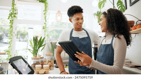 Coffee shop, barista and communication with tablet for teamwork, discussion and ecommerce at cafe. Small business, people and waitress with technology for website update, schedule or inventory check - Powered by Shutterstock