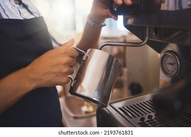 Coffee Shop, Barista And Waitress Working In A Cafe And Pouring A Fresh Drink In A Restaurant While In An Apron. Closeup Of A Hand Foaming Or Steaming Milk In The Service And Hospitality Industry.