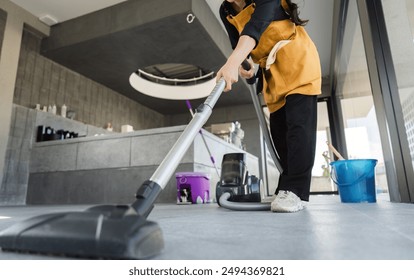 Coffee Shop Cleaning Staff Vacuuming Floor in Modern Cafe Interior with Cleaning Equipment - Powered by Shutterstock