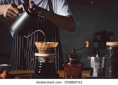 Coffee shop concept : Professional barista preparing coffee using chemex pour over coffee maker and drip kettle. Alternative ways of brewing coffee.