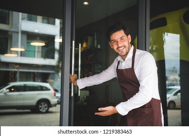 The Coffee Shop Owner Is Opening The Door, Inviting Customers To His Shop. Setup Studio Shooting.