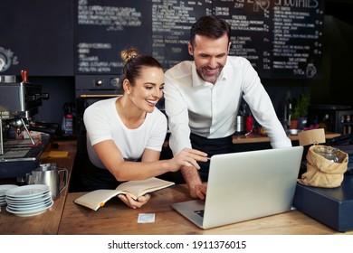 Coffee Shop Small Business Owners Working With Laptop 