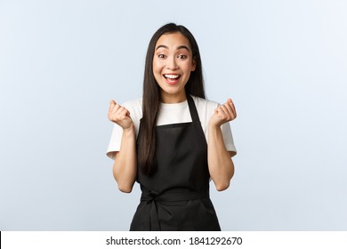 Coffee Shop, Small Business And Startup Concept. Cheerful Asian Girl Winning, Best Employee Month, Fist Pump And Rejoicing. Happy Barista Jumping Enthusiastic, Winning Competition