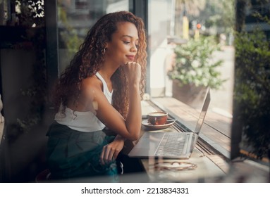 Coffee Shop, Thinking And Black Woman Working On Laptop, Reading To Relax In Cafe. Student Doing Work On Computer On Coffee Break To Think Of Ideas, Inspiration And Motivation To Do Project By Window