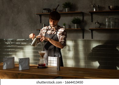 Coffee shop worker standing at the counter with hand drip coffee set - Powered by Shutterstock