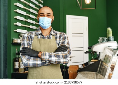 Coffee Shop Worker Wearing Medical Mask While Standing At Counter In Cafeteria