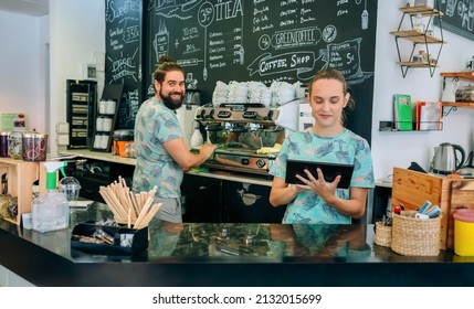 Coffee Shop Workers Posing Cleaning Coffe Maker And Using Tablet