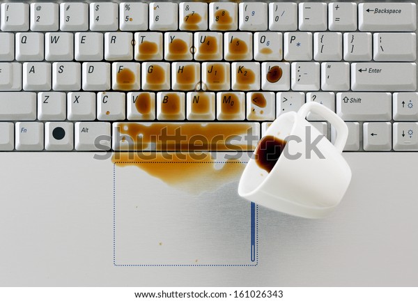 Coffee spilled on\
keyboard close up shot