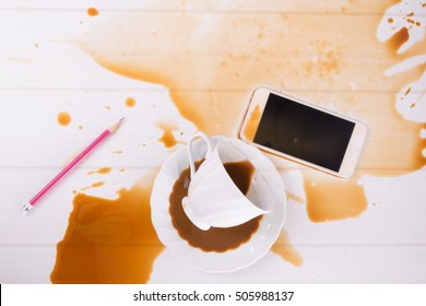 Coffee Spilled To Smart Phone On Table