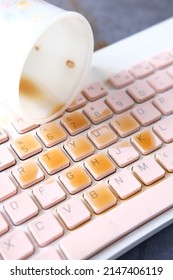 Coffee Spilling On Laptop Keyboard. Close Up 