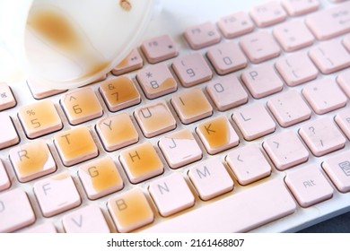 Coffee Spilling On Laptop Keyboard. Close Up 