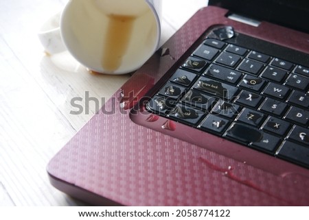 coffee spilling on laptop keyboard. close up 