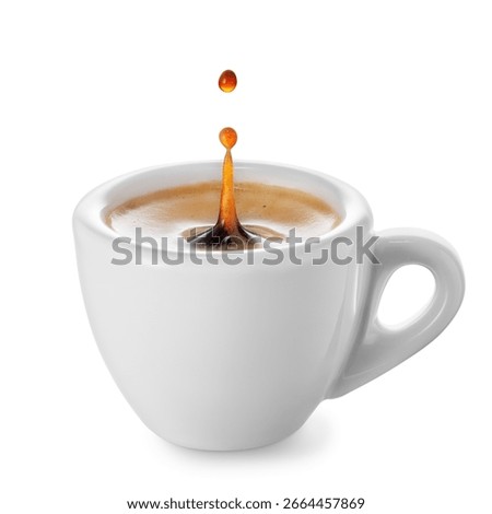Coffee splash with drop inside small ceramic espresso cup isolated on white background. File contains clipping path