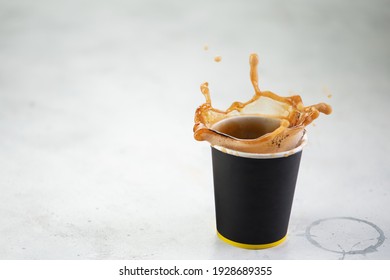 Coffee Splash From A Paper Cup On White Background