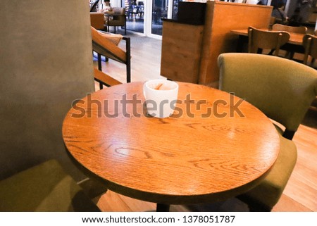 Coffee stain on almost empty white cup on wooden table.