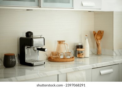 Coffee station at home with jar of water, bottle of milk and coffee machine