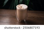 Coffee steamed with cream, Raf coffee, delicious popular drink. Glass cup of raf beverage in coffee house or bar counter. Whipped halva raff coffee drink in a glass