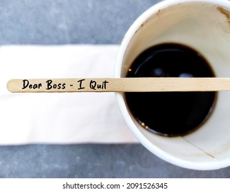 Coffee stirer with text handwritten DEAR BOSS I QUIT on coffee cup, decision making to quit job or resign from corporate full time work, employee voluntarily leaving job to find work life balance