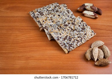 Coffee, Sweets And Nuts On A Wooden Background. Whole Grain Flour Cookies With Sunflower, Flax And Sesame Seeds. Brazil Nut And Pecan. Background Of Light Golden Alder, Varnished. Concisely.