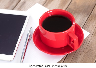 Coffee and tablet on the table