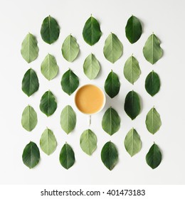 Coffee Or Tea On Green Leaves Pattern On White Background. Flat Lay.