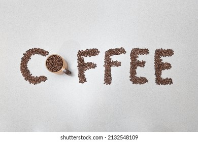 Coffee text word made from beans written on white kitchen counter background 