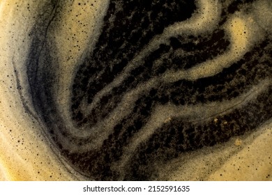 Coffee texture background. Strong espresso extreme dark coffee brown froth closeup 