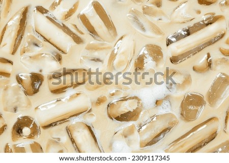 Coffee texture and macro ice cubes,Close-up of Cold latte drink with ice cubes, 