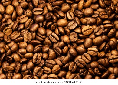 Coffee texture. Roasted coffee beans as background wallpaper. Beautiful arabica real cofee bean illustration for any concept. Gourmet coffee beans macro closeup studio photo.