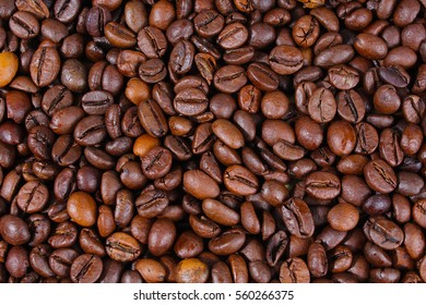 Coffee texture. Roasted coffee beans as background wallpaper. Beautiful arabica real cofee bean illustration for any concept. Gourmet coffee beans macro closeup studio photo.