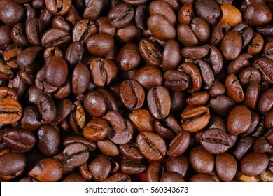 Coffee texture. Roasted coffee beans as background wallpaper. Beautiful arabica real cofee bean illustration for any concept. Gourmet coffee beans macro closeup studio photo. 