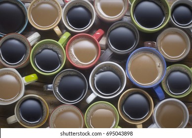 coffee time - lots of coffee in different cups. coffee lover - top view of many cups of coffee on wooden table good background for text or graphic design