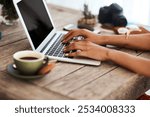 Coffee, typing and person with laptop, desk and breakfast for fiction writer, hands and creative. Research, entrepreneur and self publishing on website, editing and planning for launch of ebook