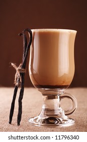 Coffee Vanilla Latte With Vanilla Bean In Tall Glass On Hessian Background, Shallow DOF