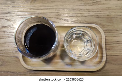 Coffee and water background, black coffee and a glass of water close view