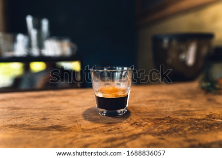 Similar – Image, Stock Photo a small glass of coffee and a white flower on a walnut table