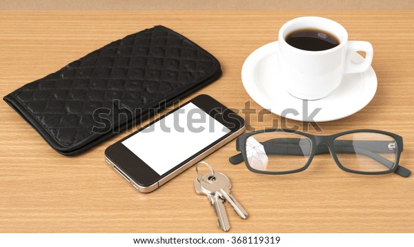 coffee,phone,key,eyeglasses and wallet on wood\
table\
background