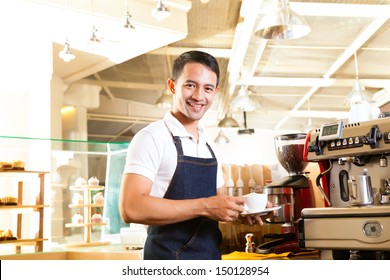 Coffeeshop - Asian Barista Presents Coffee In His Shop